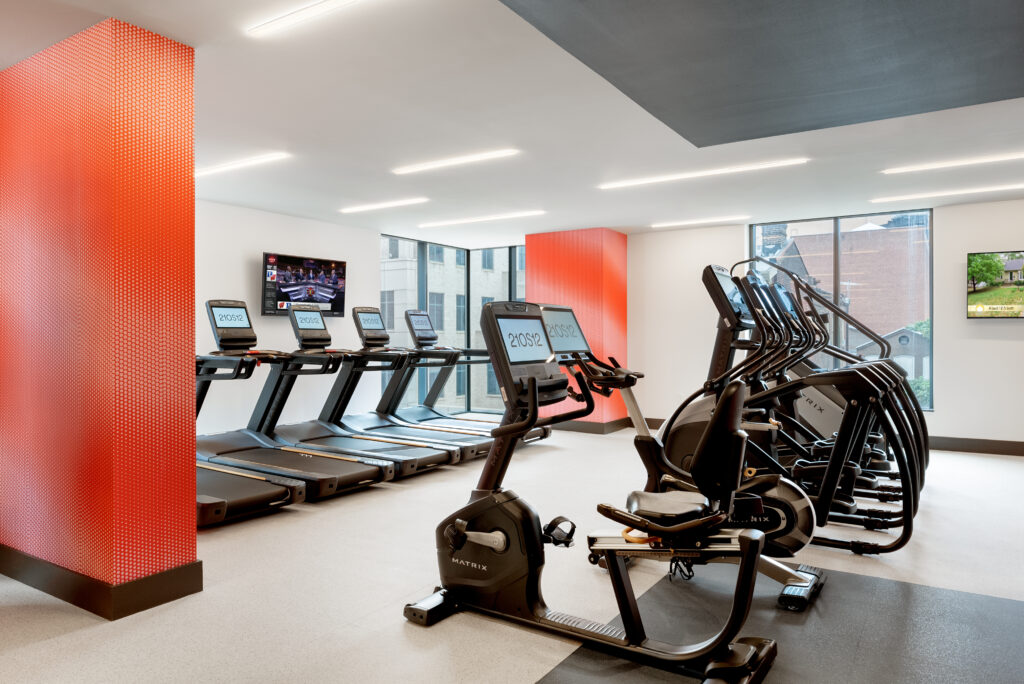 Fitness Center with several treadmills, ellipticals, and bikes