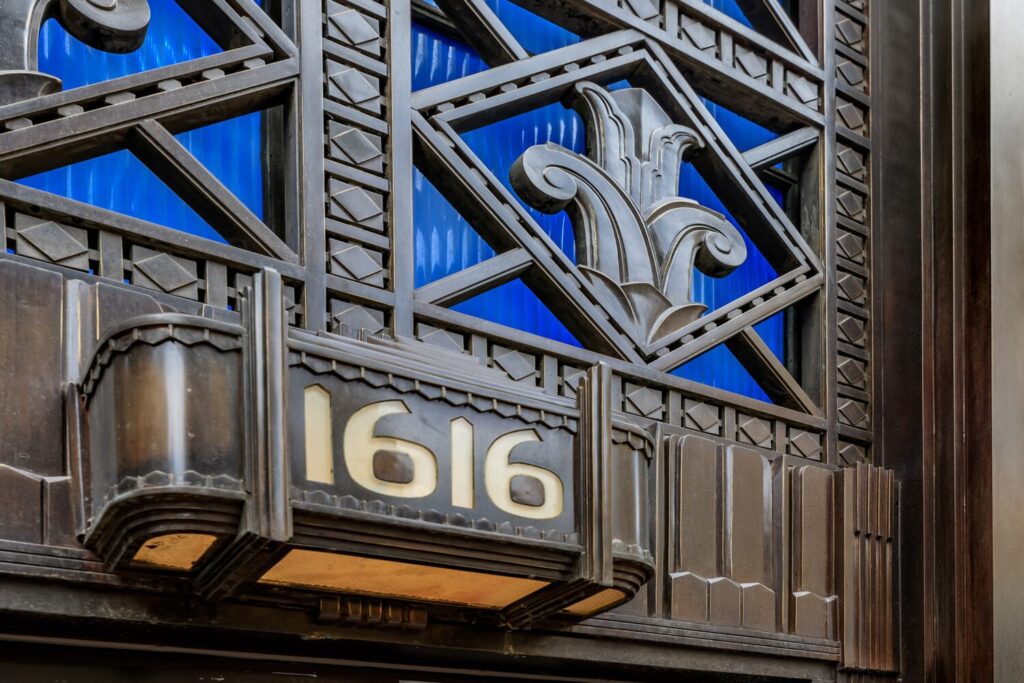 Front of ICON, art deco style exterior with "1616" written in yellow gold