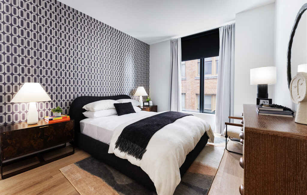 Bedroom with a large window and black and white wallpaper