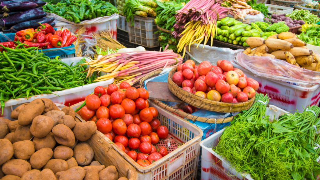 Crates full of farm-fresh vegetables and fruits at a farmers market