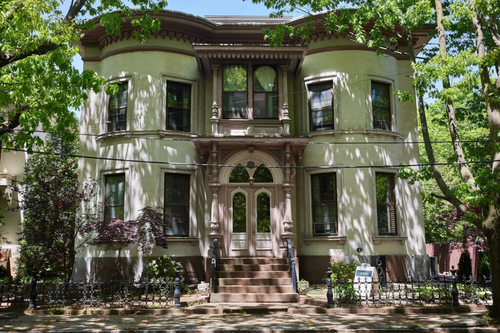 A historic home in Wooster Square with trees and shade