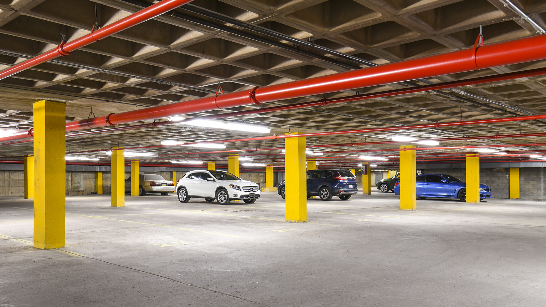 Car garage with a few cars parked within